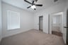 guest bedroom with carpet and window