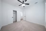 guest bedroom with carpet and walk-in closet