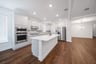 open kitchen with white cabinets and hardwood flooring