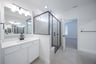 spacious primary bathroom with walk-in shower