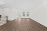 great room with stair railing and hardwood floors