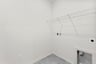 walk-in closet with white rack on top