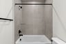 Secondary bathroom with shower and tub with black hardware and tile