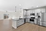 kitchen with quartz countertops and gray cabinets