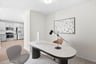office with desk, artwork, and chairs