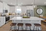 kitchen with wooden barstools and white marble island