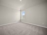 bedroom with carpet, sloped ceiling & a window
