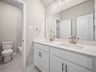 bathroom with dual sinks & a bathtub with shower combo