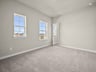 bedroom with carpet, a window & a sloped ceiling