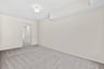 primary bedroom with overhead lighting and carpet