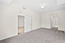 primary bedroom with carpet and overhead lighting