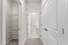 primary bedroom hallway to bathroom and closets