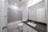 bathroom with tub and tile 