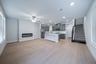 great room with electric fireplace and wood flooring 