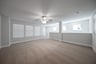 loft with windows with blinds and carpet 