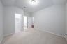 guest bedroom with carpet and walk-in closet