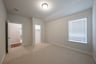 guest bedroom with carpet and walk-in closet