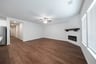 open great room with electric fireplace and hardwood flooring
