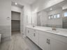 bathroom with soaking tub, walk-in shower & dual sinks
