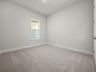 bedroom with carpet, window & recessed lighting