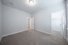 guest bedroom with carpet and walk-in closet