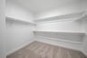 closet with hanging racks and carpet 