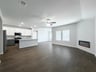 great room with wood flooring and electric fireplace 
