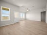 great room with a window, recessed lighting & brown flooring