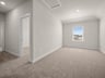 loft with carpet, recessed lighting & a window