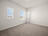 bedroom with windows, carpet & a sloped ceiling