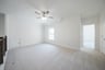 spacious game room with carpet and ceiling fan