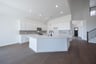 open kitchen with white cabinets and hardwood flooring